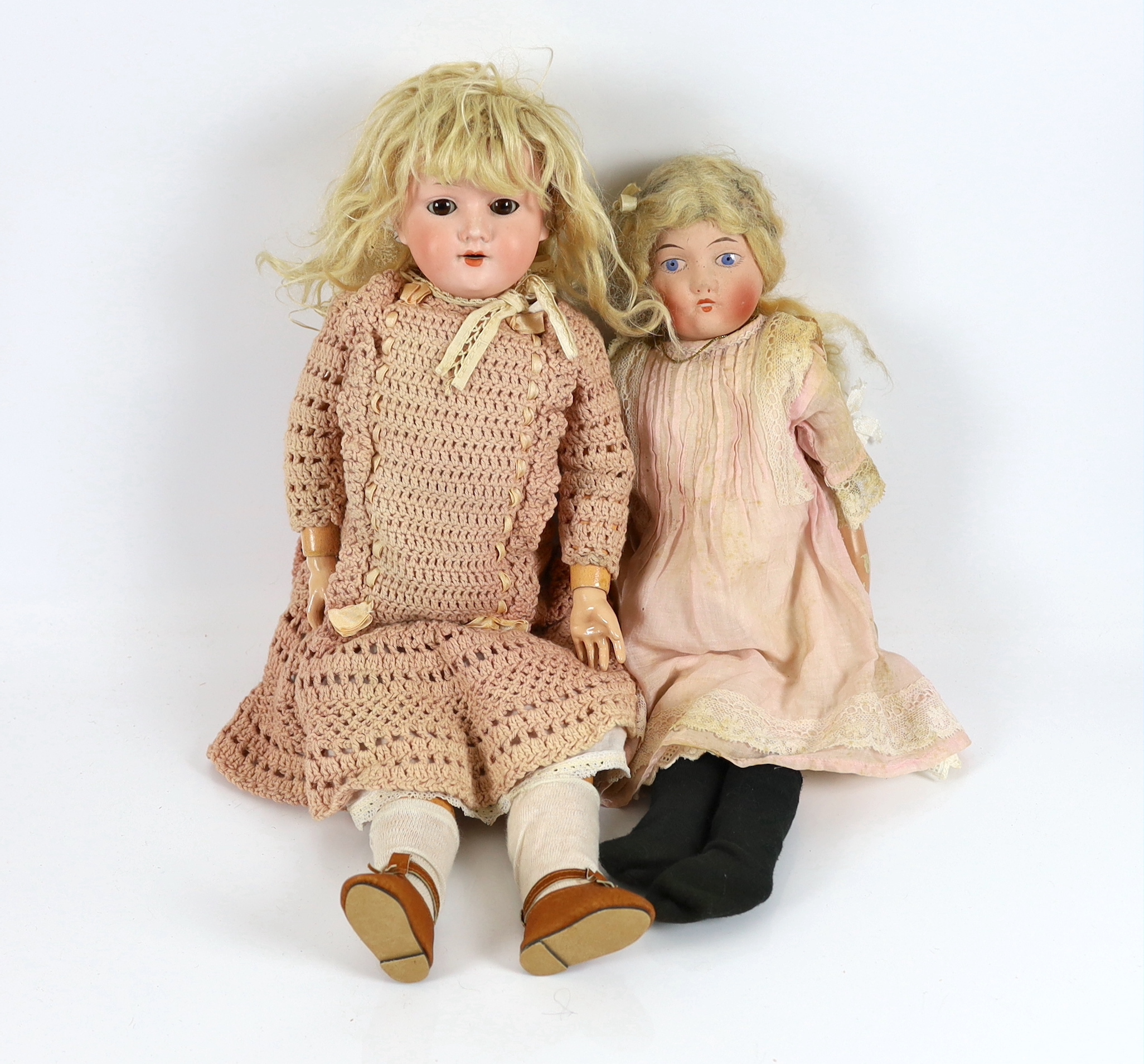 An AM 390 on jointed body with original dress and wig, 50cm, together with an English doll soft body, 45cm